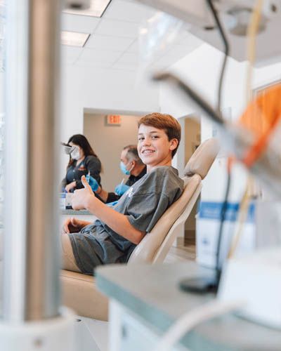 young teenager smiling during his dental appointment at Smile Team Pediatric Dentistry